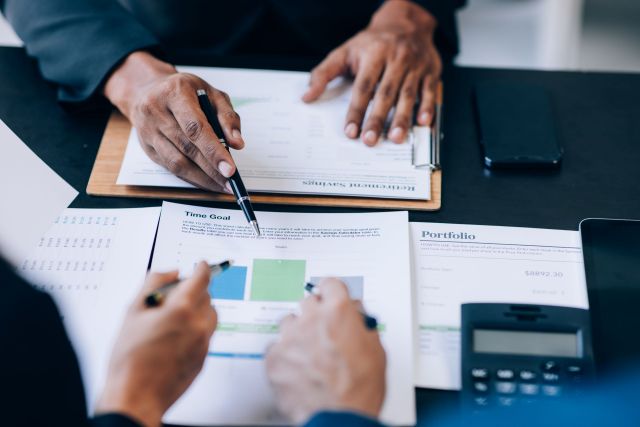 Close up view of business people discussing the charts and graph