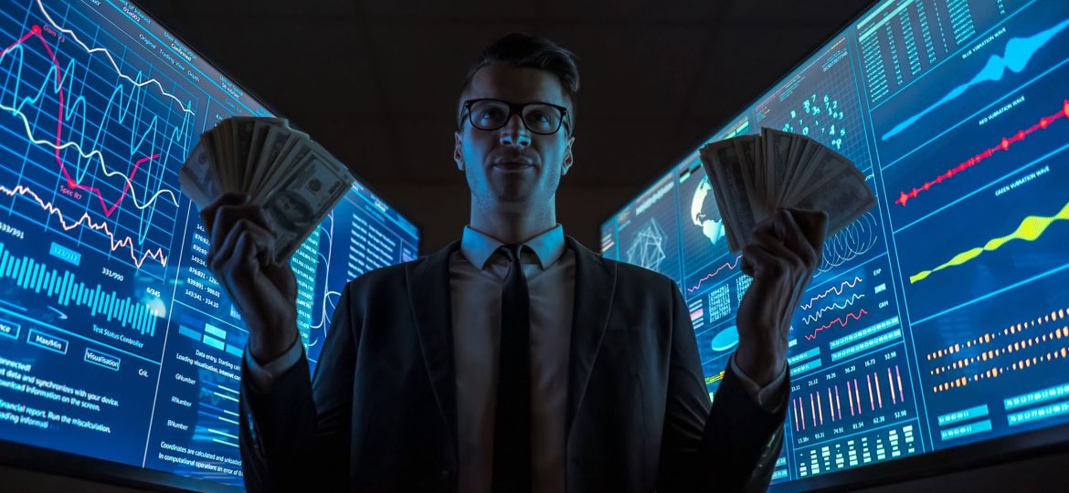 The smiling businessman holding dollars in his hands